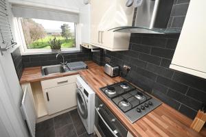 a small kitchen with a stove and a sink at 2 Bedroom Flat, Fabulous Views near Beamish Museum in Beamish