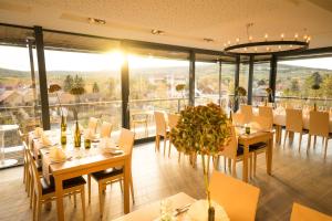 a restaurant with tables and chairs and a large window at Weindomizil Hagn in Mailberg