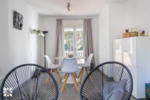 a dining room with two chairs and a table at Villa La Morena by Abahana Villas in Fanadix +16 photos