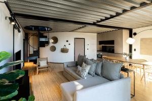 a living room with a couch and a table at Feel Porto Matosinhos City Flats in Matosinhos