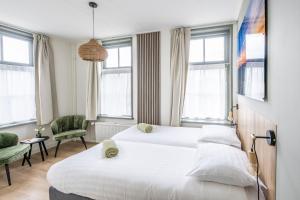 Postel nebo postele na pokoji v ubytování Hotel Over de Brug + 14 fotografií
