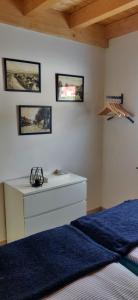 a bedroom with a bed and a white dresser and pictures at Haus Linda in Plau am See +18 photos