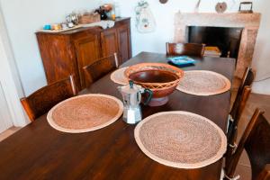 a wooden table with three plates on top of it at Maison Trullo in Ceglie Messapica