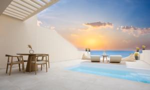 a villa with a view of the ocean at Pnoe Luxury Suites in Fira