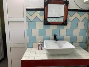 a bathroom with a sink and mirrors on a counter at hotel pillows in Martvili +23 photos