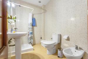 a bathroom with a toilet and a sink at Somar in Puerto de las Lajas +12 photos