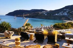 a patio with chairs and a view of the water at Sea Side Studios & Houses in Kalo Livadi