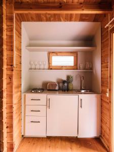 a kitchen with white cabinets and a sink at wecamp Cudillero in El Pito
