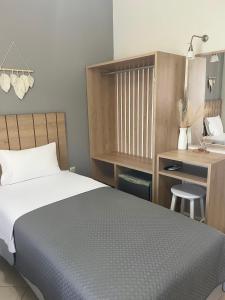 Postel nebo postele na pokoji v ubytování Rondo's Hotel