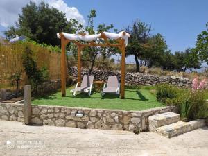 a gazebo with two chairs and a table at Villa in idyllic quiet nature in Benettáta