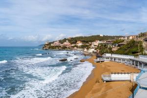 a view of a beach with houses and the ocean at Hotel Corallo in Castiglioncello +26 photos