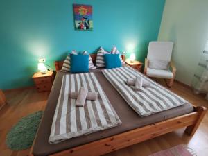 a bedroom with a large bed with towels on it at Sonnenoase in Deutschkreutz