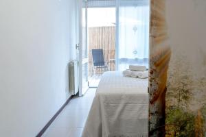 a bedroom with a bed and a balcony with a view at La stella del lago Luxe in Arona +32 photos