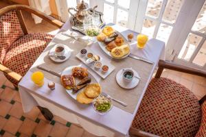 a table with a tray of breakfast foods on it at Albakech Boutique Hôtel & Spa in Marrakech