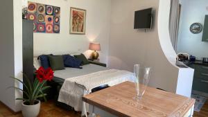 a small bedroom with a bed and a table at Home Garden in Roseto degli Abruzzi