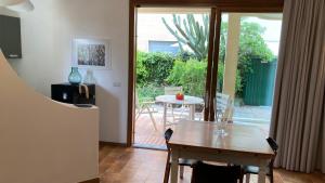 a dining room with a table and a sliding glass door at Home Garden in Roseto degli Abruzzi