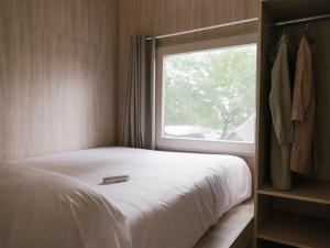 a bedroom with a bed and a window at wecamp Cudillero in El Pito