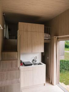 a kitchen in a tiny house with a sink at wecamp Cudillero in El Pito