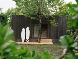 two surfboards are standing in front of a house at wecamp Cudillero in El Pito