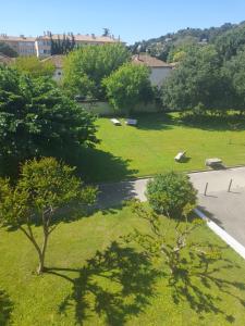 a view of a park with trees and a street at chez MARINO antony real in Orange