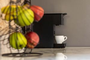 a bunch of bananas on a counter with a coffee cup at Vivari Stone House in Vivari