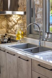 a kitchen with a sink and a counter top at Vivari Stone House in Vivari +41 photos