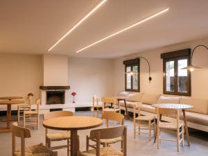 a living room with tables and chairs and a couch at wecamp Cudillero in El Pito