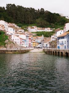 a town with a bridge over a body of water at wecamp Cudillero in El Pito