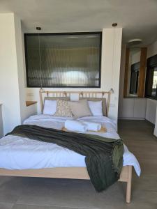 a bedroom with a large bed with two pillows at קציר ריזורט in Migdal
