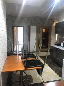 a table with two chairs sitting on it in a kitchen at Apartmánový Wellness Garni Hotel Relax in Senec