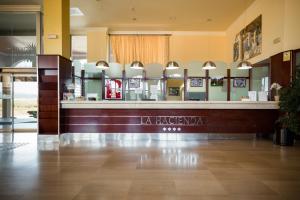 a lobby of a hotel with a reception counter at Ohtels La Hacienda in La Pineda +30 photos