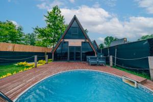 a house with a swimming pool with a wooden deck at Kurtköy Park Bungalov Evleri in Sakarya