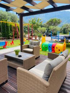 a patio with a playground with a table and chairs at Summer Dreams Studios in Skala Potamias