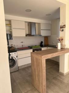 eine Küche mit einer Theke und einer Waschmaschine in der Unterkunft villa marina in Villa General Belgrano