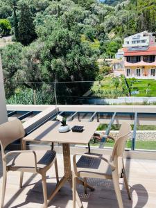 a table and two chairs on a balcony with a view at Nobile Boutique Hotel in Agios Gordios