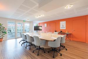 a conference room with a large table and chairs at Appart'City Classic Reims Parc des Expositions in Reims