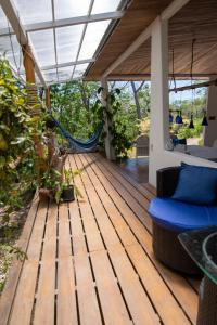 a wooden deck with a hammock on a house at Marbella Retreats Casa Azul in Santa Cruz +13 photos