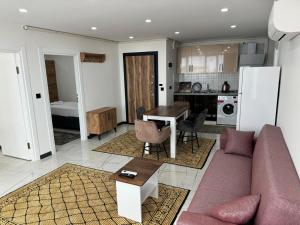 a living room with a couch and a table at MERKEZ Rezidans Suits in Trabzon