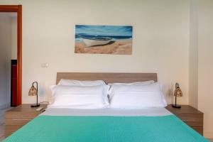 a bedroom with a bed and a painting on the wall at La Casetta-10 min Aeroporto e spiaggia in Fiumicino