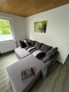 a living room with a couch and a window at Ferienwohnung am Fuße Honberg in Tuttlingen