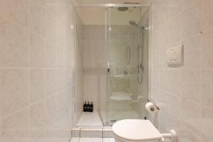 a bathroom with a shower with a toilet and a sink at La Casetta-10 min Aeroporto e spiaggia in Fiumicino +17 photos