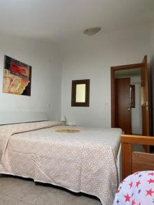 a bedroom with a bed and a mirror at La Locanda Del Re in Villalfonsina