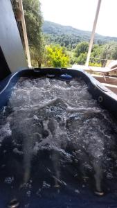 a hot tub filled with water with a view at Holiday Home Matthäus am Corfutrail, Ferienoase im Olivenhain 3 km zum Meer in Giannádes