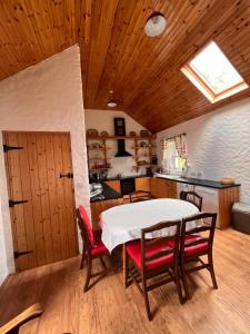 a kitchen with a table and chairs in a room at Mia's Self Catering Holiday Cottage Donegal in Claggan