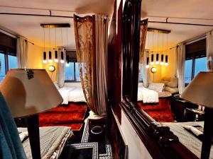 a train room with four beds and a mirror at Ashkelon-apart-hotel-boho style-standard deluxe in Ashkelon
