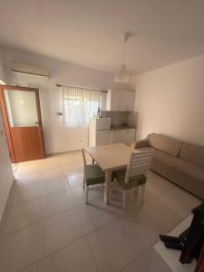 a kitchen and a living room with a table and chairs at Villa B&E 2 in Vlorë