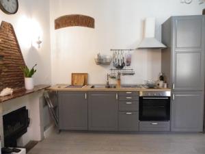 a kitchen with a sink and a stove at Chez Sophie in La Spezia
