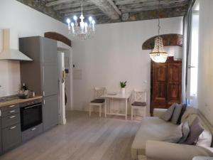 a kitchen and living room with a couch and a table at Chez Sophie in La Spezia +7 photos