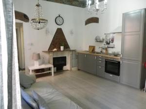 a kitchen with a living room with a fireplace at Chez Sophie in La Spezia