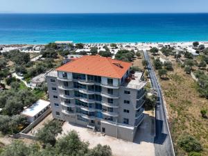 an aerial view of a building next to the ocean at Hotel Borshi in Borsh